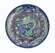 A Chinese charger with a blue ground and green decoration depicting with dragons, flaming pearl