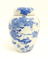 A Japanese blue and white ginger jar / tea caddy decorated with flowers and foliage. Approx. 7 3/