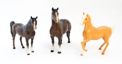 Three Beswick models of horses to include a Prancing Arab palomino, a brown Arab horse, and another.