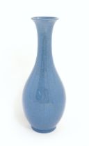 A Chinese vase of elongated form with blue ground and crackle glaze. Approx. 16 1/2" high Please