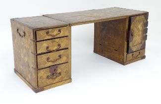 An early 20thC double pedestal table cabinet with parquetry detail comprising seven drawers, two