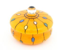 A Continental retro glass powder bowl with orange body and cover and painted detail, inspired by the