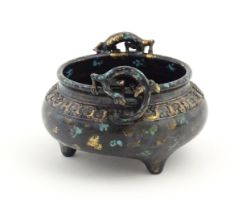 A Chinese censer with twin handles of stylised salamander form with relief banded decoration.