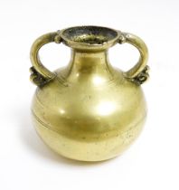 An Asian brass twin handled vase with banded detail. Approx. 3 1/2" high Please Note - we do not