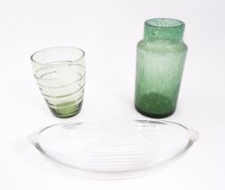 Three items of glassware to include a trailed green glass vase, a green soda glass jar / vase, and a