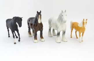 Four Beswick models of horses comprising a brown Shire Mare and a dapple grey Shire Mare model no.