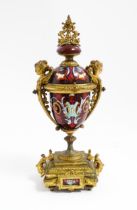 A late 19th / early 20thC single garniture of urn form with painted detail and gilt figural and