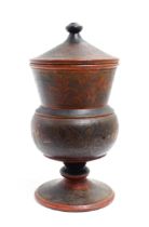 A Scandinavian folk art pedestal pot and cover with turned and lacquered foliate decoration. Approx.