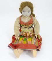 Toy: A 20thC French doll with bisque head, glass eyes, painted features and a composite body with