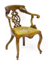 A 19thC walnut armchair with a bowed top rail, pierced and carved back splat above scrolled arms