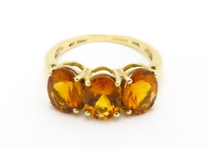A 9ct gold ring set with three citrine. Ring size approx. L 1/2 Please Note - we do not make