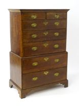 A late 19thC oak chest on chest, with a moulded cornice above two short over five graduated