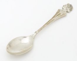 A silver commemorative / souvenir spoon the handle surmounted by an image of Queen Elizabeth II,