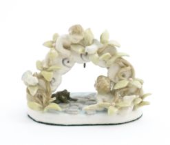 A late 19th / early 20thC novelty ceramic pocket watch stand modelled as a pond with lily pads,