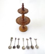 A turned wooden two tier spoon stand, together with seven assorted silver plate commemorative /