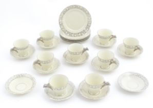 A quantity of Art Deco style tea wares with banded detail comprising plates, cups and saucers.