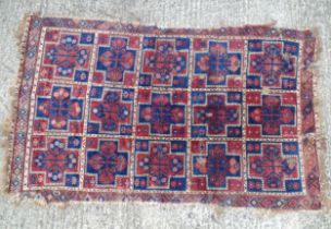 Carpet / rug : A red and blue ground rug with geometric motifs and blue detail, approx 90 1/2" x 55"