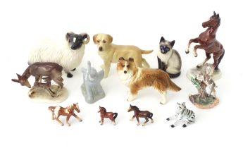 A quantity of assorted ceramic models of animals to include cat, dog, deer, elephant, zebra, horses,