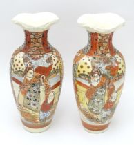 A pair of Japanese vases decorated in the satsuma palette. Character marks under. Each approx. 10"