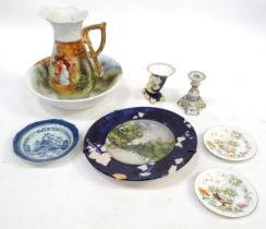 A quantity of ceramics to include a faience style candlestick, two plates with a rocky outcrop,