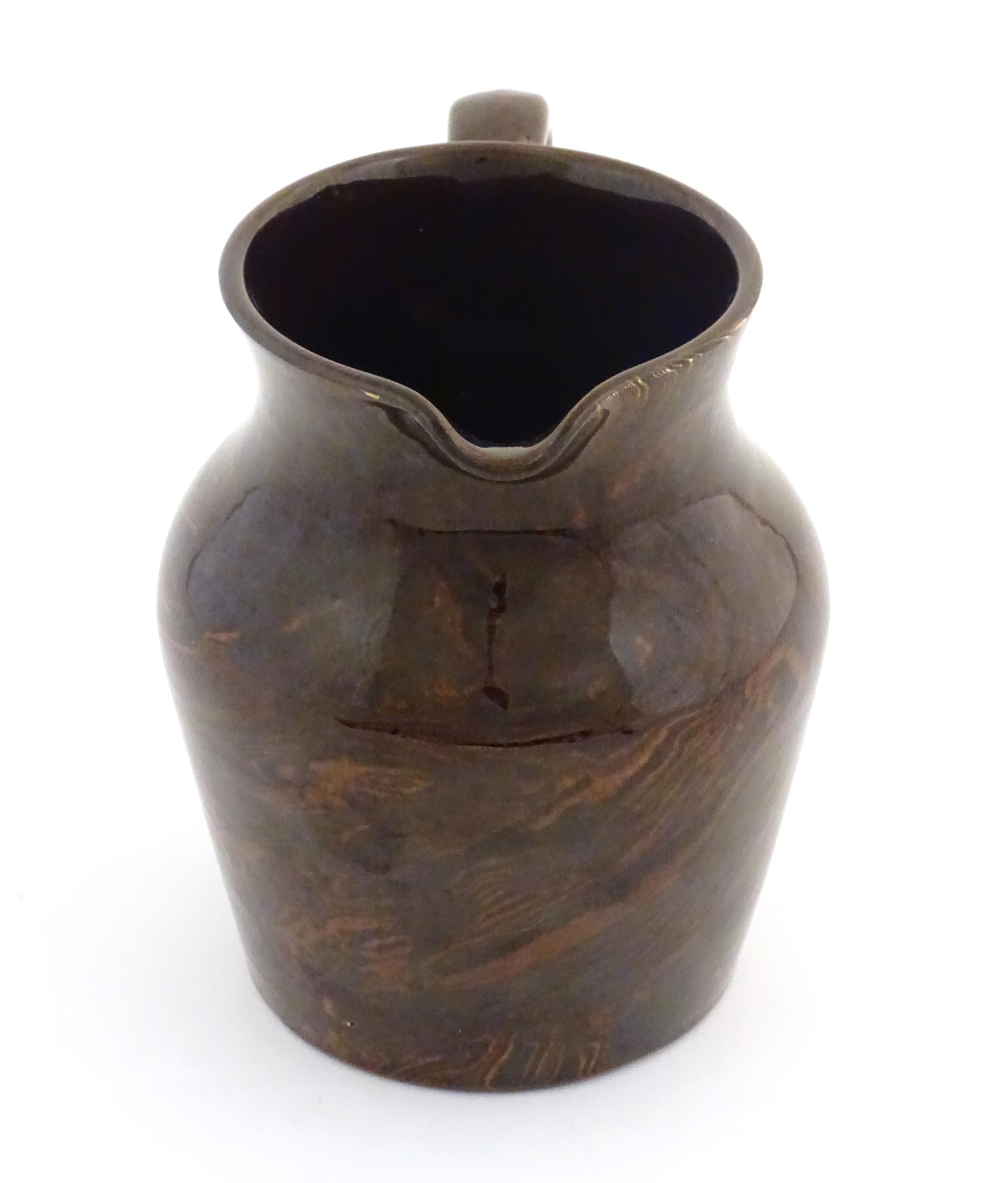 An agate wear jug with loop handle. Approx. 4 1/2" high Please Note - we do not make reference to - Image 2 of 7