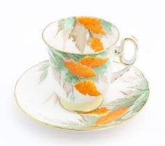 An Art Deco Shelley cup and saucer decorated in the Orange Wisteria pattern. Marked under. Cup