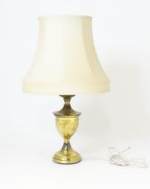 A brass table lamp of urn form, standing approx 22 1/2" high (inc. shade) Please Note - we do not