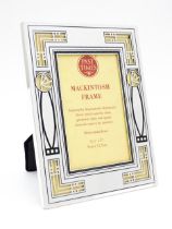 An easel back photograph frame with silver plate surround with Mackintosh inspired floral motifs,