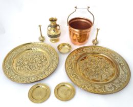 A quantity of assorted brass and copper wares to include chargers, dishes, vase, etc. Please