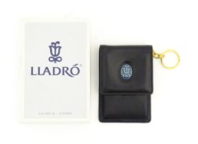 A Lladro coin purse / wallet with porcelain logo. Boxed. Approx. 4" x 2 3/4" Please Note - we do not