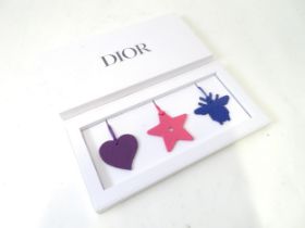 A boxed set of three Dior bag / luggage tags / charms Please Note - we do not make reference to