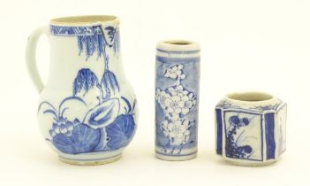 A Chinese blue and white jug decorated with trees, leaves, flowers and foliage. Together with a