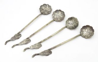 A set of four Continental white metal salt spoons with floral detail to bowls and foliate handles.