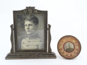 A Victorian easel back photograph frame of circular form with woven textile floral border.