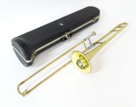 A late 20thC Blessing Scholastic trombone, approx 45" long, together with fitted case Please