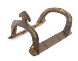 A hardwood camel saddle frame with brass mounts and punchwork detail. Approx. 17 3/4" long Please