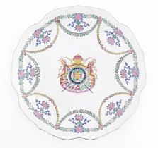 A Chinese style armorial plate with crest to centre and swag / garland detail to border. Approx.