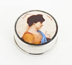 A .925 silver pill box of circular form with enamel portrait to top. Approx. 1" diameter Please Note