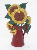 A cast iron doorstop modelled as blooming sunflowers in a jug. Approx 11" high Please Note - we do