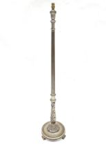 A 20thC carved wooden standard lamp with a fluted and foliate column, circular stepped base and