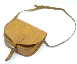 Shooting : a late 20thC tan leather cartridge bag, with shoulder strap, choke compartment and pocket