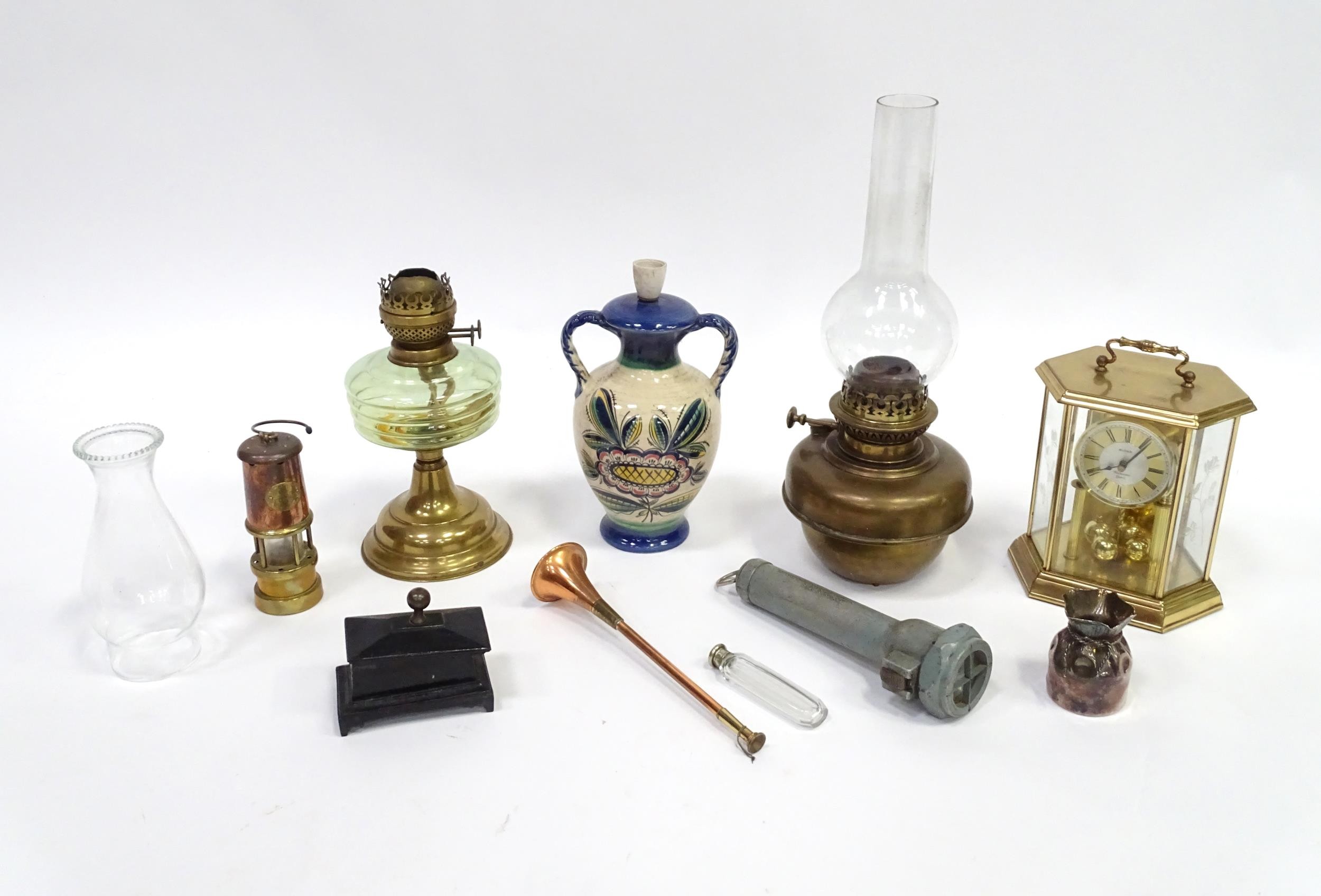 A quantity of assorted items to include clock, oil lamp sections, torch, pot and cover,