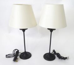 A pair of modern cast metal table lamps in blacked finish, each approx 22" tall (2) Please Note - we