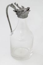 A glass whiskey water jug / noggin with stags head detail to top. Approx 6" tall Please Note - we do