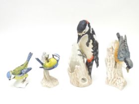 Four assorted Goebel models of birds to include Blue Titmouse, Great Spotted Woodpeckers, and