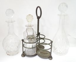 Various glass decanters with a silver plate bottle stand and a silver plate decanter label.
