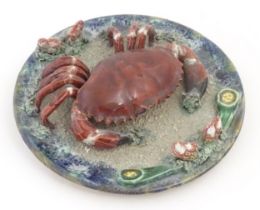 A Palissy style plate with relief crab and shell detail. Approx. 9 3/4" diameter Please Note - we do