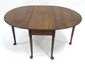 A Georgian oak country-made gateleg dining table, standing on six pad feet, extending to approx