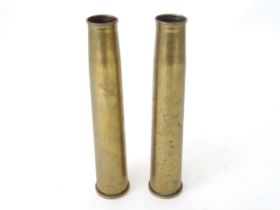 Two brass 40mm Bofors cannon shell cases, each bearing Ministry of Defence forward arrow marks and