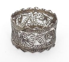 A white metal napkin ring with filigree style decoration Please Note - we do not make reference to